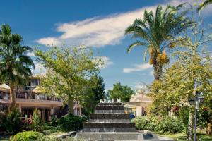 a set of stairs with palm trees and buildings at Selectum Collection Bodrum in Akyarlar