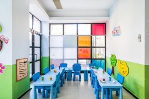 a classroom with blue tables and blue chairs at Selectum Collection Bodrum in Akyarlar