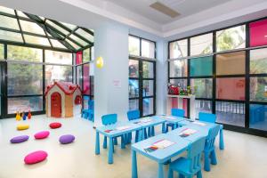 a classroom with blue tables and a toy house at Selectum Collection Bodrum in Akyarlar