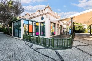 a house with a green fence in front of it at Selectum Collection Bodrum in Akyarlar