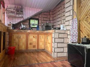 a kitchen with a christmas tree on a brick wall at Be my guest at Hills in Kulu