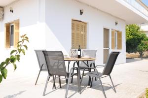 a table and chairs on a patio at The Byzantine Wall House in Isthmia
