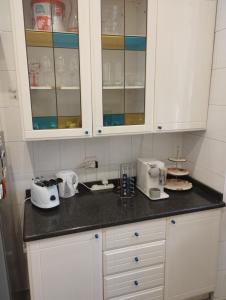 a kitchen with white cabinets and appliances on a counter at Casa Nonna Anna in Genoa