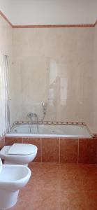 a bathroom with a tub and a toilet and a sink at Lovin Puglia Vacation in Bari