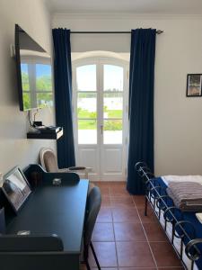 a room with a bed and a window with a door at Quinta da Varzea in Raposa