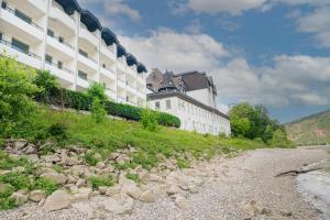 ein Gebäude neben einem Fluss neben einem Gebäude in der Unterkunft besttime Hotel Boppard in Boppard