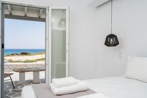 a bedroom with a bed and a view of the ocean at Celestial Seaview Apartments-Dionysios in Naxos Chora