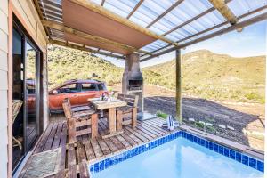 a patio with a table and chairs next to a pool at Tibani Nature Reserve in Rietvlei Number 1