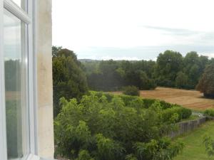 a view from a window of a garden at Domaine de Puyrousse in Ribérac