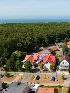 an aerial view of a small town with red roofs at Dom Pod Jeleniem in Łeba
