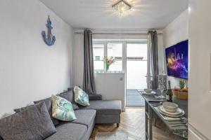 a living room with a couch and a table at The Cove in Holyhead