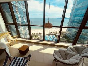 a room with a large window with a view of the beach at Haeundae Luxury House in Busan