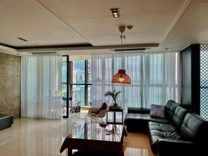 a living room with a couch and a glass table at Haeundae Luxury House in Busan