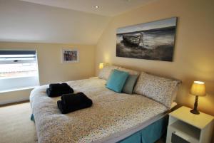 a bedroom with a bed with two black bags on it at Net Loft- homely accomodation in East Neuk in Anstruther