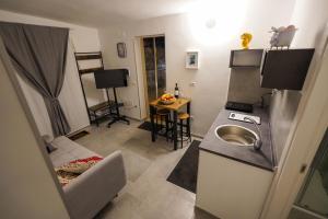 a small kitchen with a sink and a refrigerator at Piedigrotta b&b Luxury in Pizzo