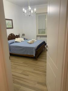 a bedroom with a bed and a chandelier at Valdonica - Relax in campagna in La Spezia