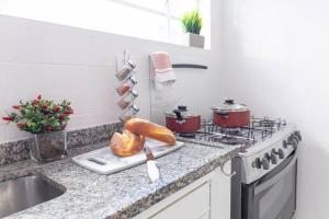 um balcão de cozinha com um fogão e um lavatório em Casa aconchegante com 4 quartos na Vila Madalena em São Paulo