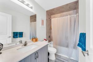a white bathroom with a sink and a toilet at Home away from Home - Remote Office - Vacation Stay in Vaughan +40 photos