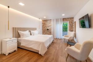 En eller flere senger på et rom på Nono Ban Hotel & Villa