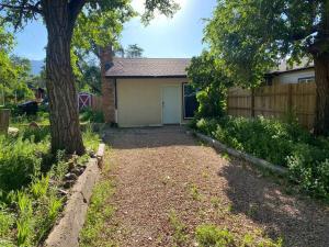 a house with a tree and a fence at 2-bedroom near hwy. 24 & I-25 in Colorado Springs