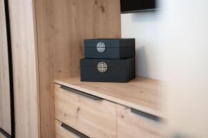 two boxes sitting on top of a wooden cabinet at Modern Home in Windermere by LetMeStay in Windermere