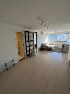 an empty living room with a couch and a table at Apartamento com Vista Imperdível in Rio de Janeiro