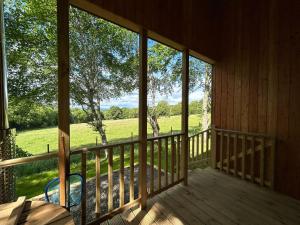 a view from the porch of a cabin at Breckland Lodge 3 with Hot Tub in Belladrum
