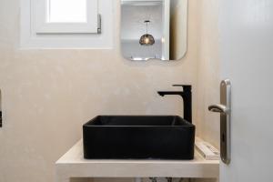 a black sink on a counter in a bathroom at Celestial Seaview Apartments-Portara in Naxos Chora +26 photos