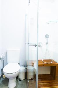 a bathroom with a toilet and a glass shower at House in Shalma in Tel Aviv
