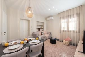 a living room with a table and a couch at My Pixida Apartments in Rhodes Town