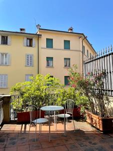 a table and chairs in front of a building at La Terrazza del Centro in Bergamo