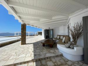 a living room with a couch and a table on a patio at Villa Faros in Fanari