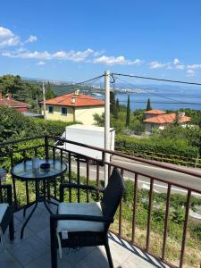 a patio with a table and chairs on a balcony at Opatija Rooms & Apartments Semić - Free Parking and Sea View in Opatija