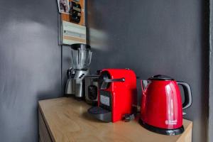 a red blender sitting on top of a wooden counter at Montmartre Superbe Studio Paris in Paris