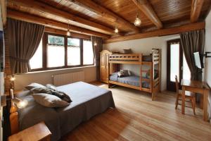 a bedroom with a bed and a bunk bed at Locanda Occitana Cà Bianca in Roccabruna