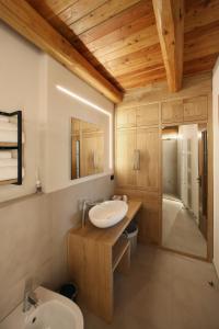 a bathroom with a sink and a toilet and a tub at Locanda Occitana Cà Bianca in Roccabruna