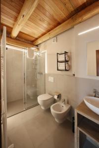 a bathroom with a shower and a toilet and a sink at Locanda Occitana Cà Bianca in Roccabruna