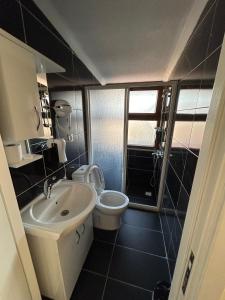 a small bathroom with a sink and a toilet at NAVAL HOTEL YALOVA in Yalova