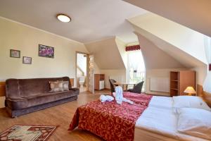 a bedroom with a large bed and a couch at VILLA DAIRA in Ustronie Morskie