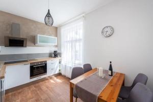 a kitchen and dining room with a table and chairs at 2 bedrooms apt near Wenceslas sq in Prague