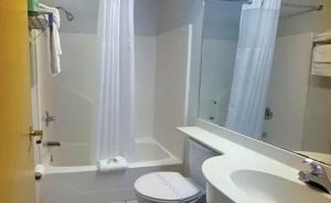 a bathroom with a sink and a toilet and a shower at Studio 6 McAlester OK South in McAlester