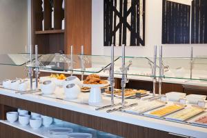 a buffet line with food on a table at AC Hotel by Marriott Lansing University Area in Lansing