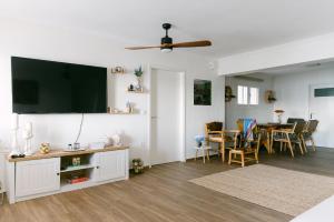a living room with a flat screen tv on the wall at Rodini House in Kato Rodini