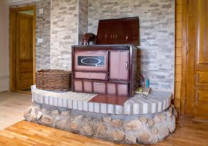 a living room with a tv on a stone wall at D&S Kovacevic Apartments Zabljak in Žabljak