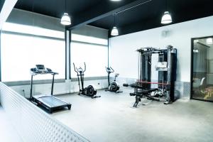 a gym with several treadmills and machines in a room at Hotel Planas in Salou