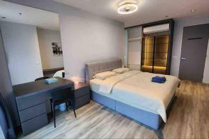 a bedroom with a large bed and a desk at Lumi Tropicana (2 in 1) sleep up to 18 in Petaling Jaya