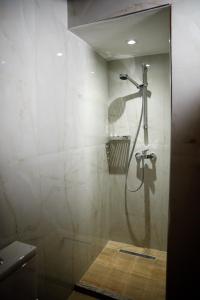 a shower with a glass door in a bathroom at Hotel Sarajet 1821 in Gjirokastër