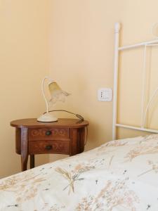 a bedroom with a bed and a table with a lamp at Luci nel Bosco B&B in Montalto +29 photos