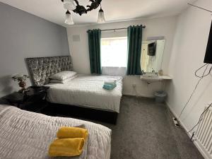 a bedroom with two beds and a sink and a mirror at 116 Maison Dieu Road Room D in Dover in Kent