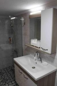 a bathroom with a sink and a shower at Cunda adasında rum evi in Ayvalık